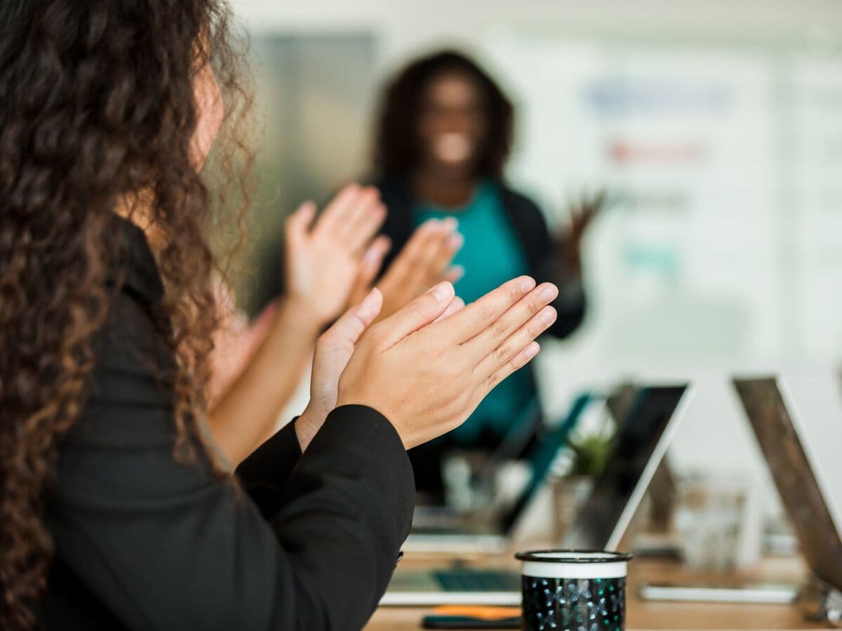 Audience applauding a speaker at a training session